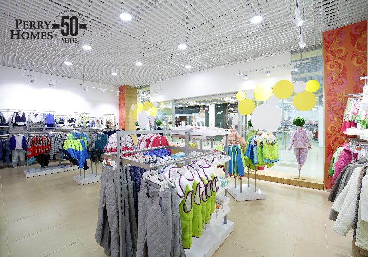 inside trendy youth clothes store with lots of colorful apparel