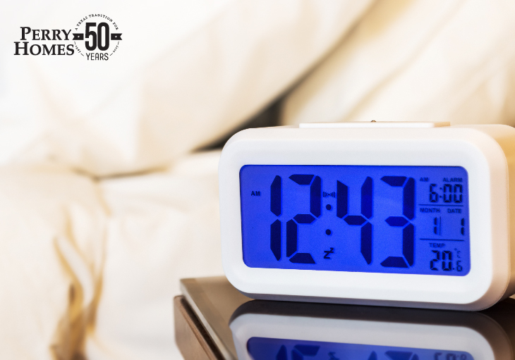 digital alarm clock on nightstand next to bed