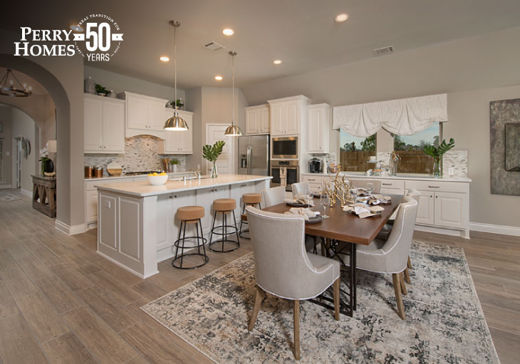 open-concept kitchen and dining area with white kitchen cabinets and countertop, pendant lights, transitional neutral décor