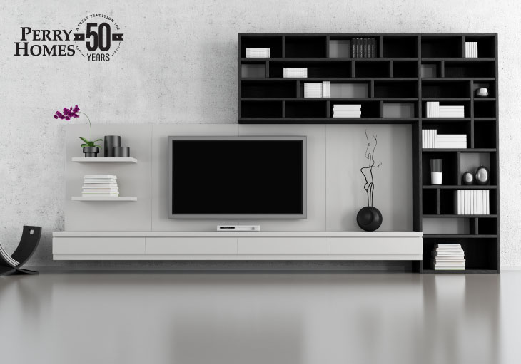 modern room with sleek smooth floor and floating tv stand next to modern black bookshelves