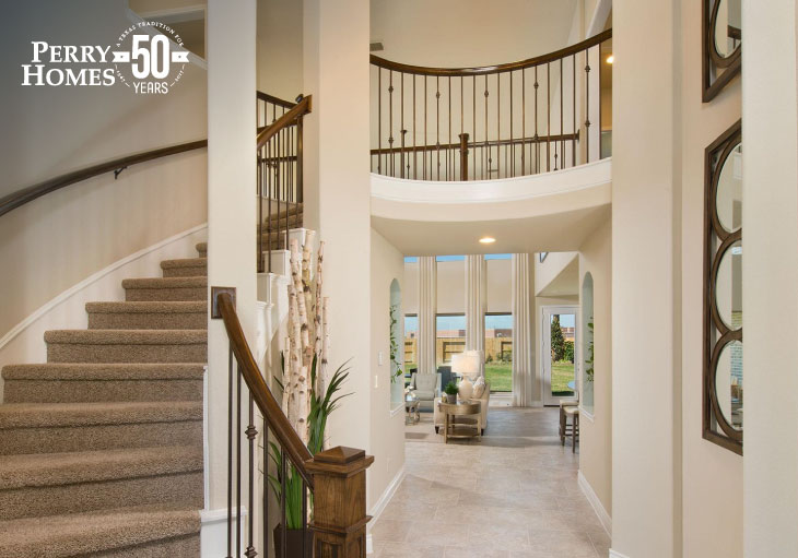 two-story foyer of home with curved staircase