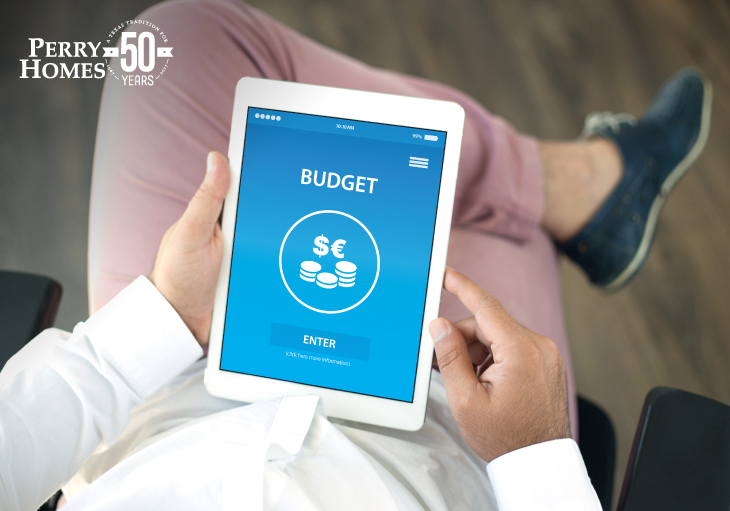a man wearing pink pants and a button up shirt holding an Ipad featuring a budgeting app 