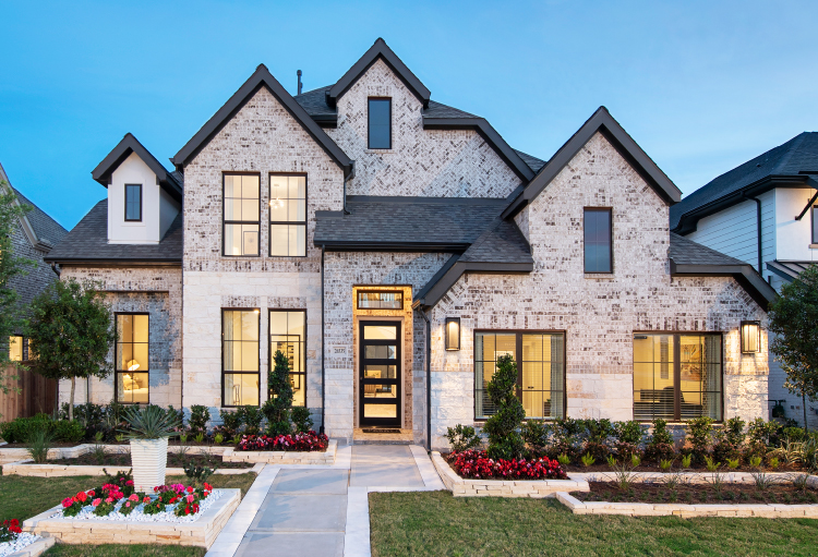 A two-story Perry home with lush landscaping and a brick exterior