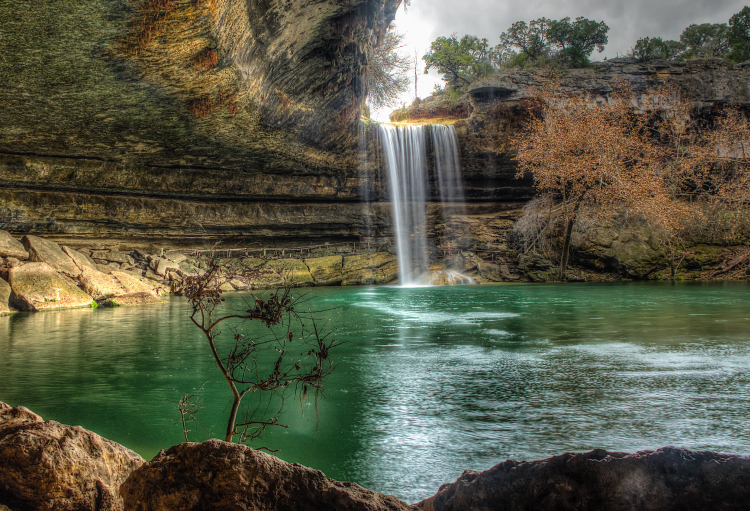 A glistening waterfall cascades water into one of Texas’ many lakes.
