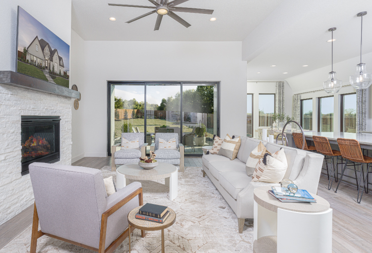 A bright, white open-floor plan showcases a spacious living room