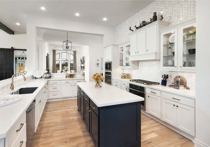Modern black and white kitchen with large island and tile backsplash in a Perry home in Texas. 