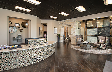 interior of perry homes austin design center that features seating, countertop selections and reception area